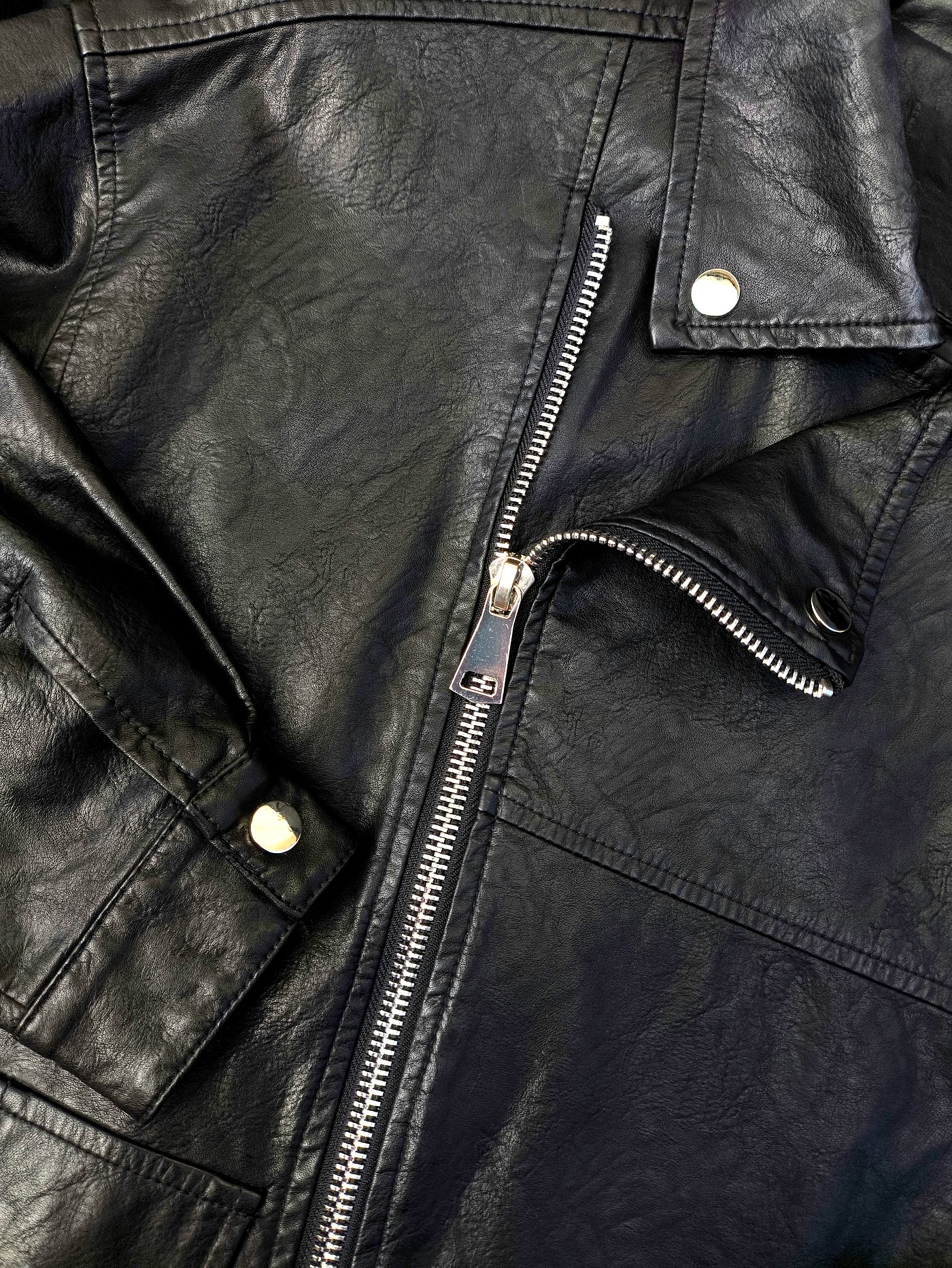 Close-up of leather jacket zipper and stitching after specialist clean